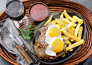 Peruvian Latin American food. Lomo a lo pobre. Beef whit fried potatoes french fry and eggs photo