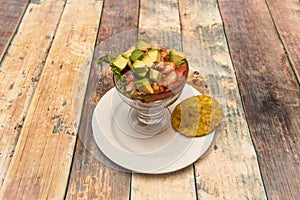 Peruvian prawn ceviche with avocado and red onion and a patacon