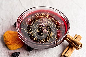 Peruvian purple jam dessert called mazamorra morada with dried fruits and cinnamon