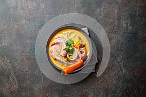 Peruvian seafood soup Chupe de Camarones in gray bowl, top view photo