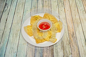 Peruvian-style wantan plate with sweet and sour sauce for dipping photo