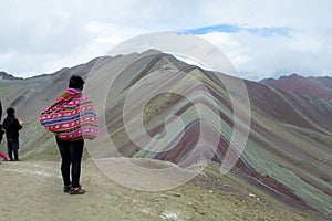 Peruvian woman watching montana De Siete Colores near Cuzco