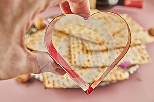 Pesah celebration concept - jewish Passover holiday. Matzah and heart-shaped item