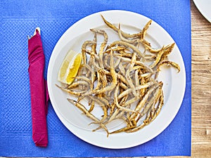 Pescaito frito, fried fish Andalusian style on a tavern table. Spanish cookery