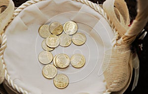 Pesetas, old Spanish coins used as earnest in a basket. photo