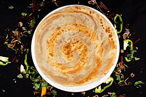 Peshawari paratha served in dish isolated on dark background top view of indian spices food photo