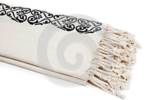 Peshtemal Turkish towel folded beige textile for spa, beach, pool, light travel, healthy fashion and gifts. Traditional turkish