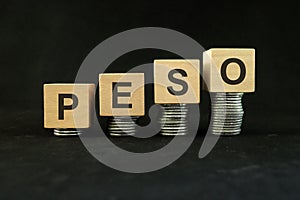 Peso currency, economic and financial growth and recovery concept. Increasing stack of coins in dark black background