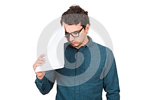 Pessimistic businessman looking down upset, as holds different paper documents  on white background. Confused business photo