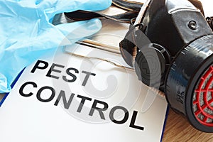 Pest control. Clipboard, respirator and gloves.