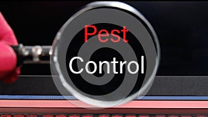 PEST CONTROL the inscription found with a magnifying glass on a black laptop monitor. Concept photo