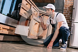 pest control worker examining kitchen