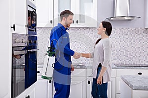 Pest Control Worker Shaking Hands With Woman