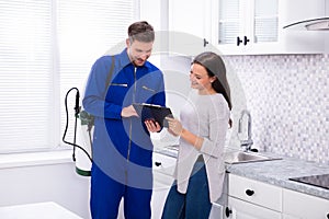 Pest Control Worker Showing Invoice To Woman