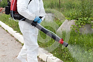 Pest control worker spraying insecticide photo