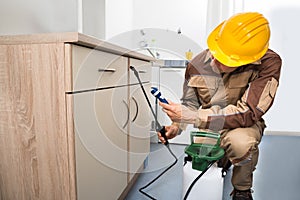 Pest control worker spraying pesticides