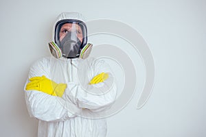 Pest control worker spraying pesticides with sprayer in apartment copy spase white walls background photo