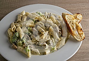Pesto Alfredo with baby spinach, penne pasta, and parmesian pesto sauce.