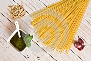 Pesto genovese and linguine pasta, pine nuts and garlic on a tab