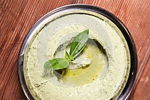 Pesto Hummus served in dish isolated on background top of arabic food cold mezza photo