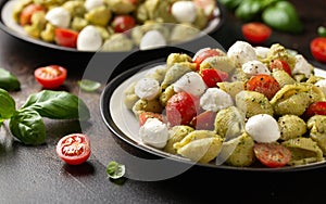 Pesto Pasta Salad with Cherry Tomatoes and Mozzarella cheese. Healthy food.