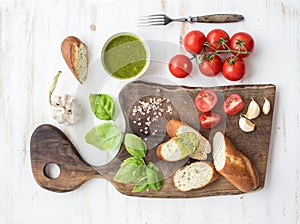 Pesto sauce, bread, cherry-tomatoes, fresh basil