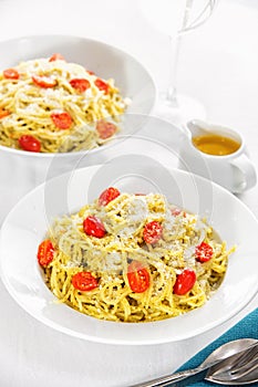 Pesto spaghetti with cherry tomato.