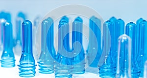 PET bottle preforms before blow molding, filling and labeling process. Blue PET bottle preform for beverage industry. Raw material