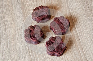 pet cake. dog treat. pastry food for cat. appetizing dog muffins on wooden background. dog birthday. red velvet. paw shaped dog