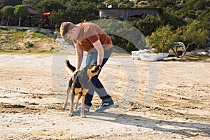 Pet, domestic animal, season and people concept - happy man with his dog walking outdoors