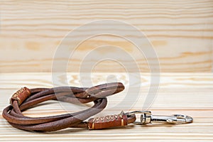 Pet leather leashes on wooden background