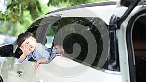 Pet lover And Asian family. Mother and child are playing a paper plane on a car with a beautiful view. The boy waved Mother and ch