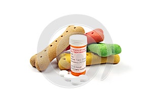 Pet medication and pill container with colored dog bone treats photo