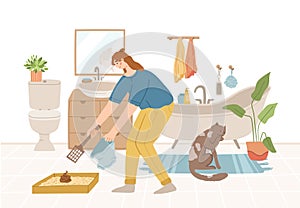 pet owner or sitter tidies up cat litter box. Girl cleaning pets toilet in bathroom, friendly pet service concept. Gray