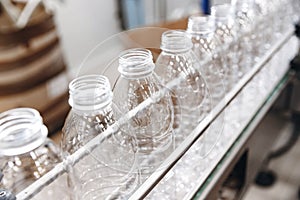 PET plastic bottles on a food automated line, milk and yoghurt bottling industry in dairy factory