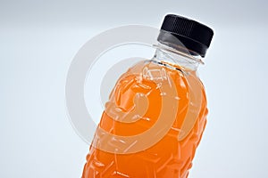 PET plastic bottles Polyethylene terephthalate black lid with fresh orange juice On a white background