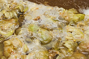 Petals and cons of hop on the surface of homet beer. close up. C