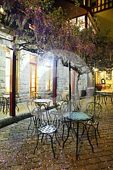 Petals covering bistro chairs night scenery