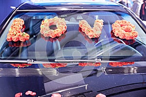 Petals of roses and flowers on a limousine from a wedding