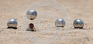 Petanque ball boules bowls on a dust floor photo