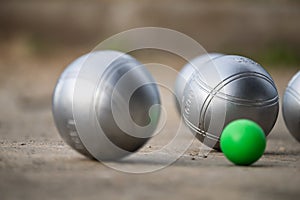 Petanque balls in the playing field with shady as a backdrop.