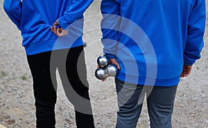 Petanque throwers seen from back photo