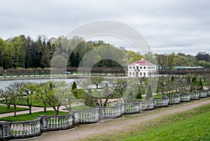 PETERHOF, RUSSIA - MAY 10, 2015: Lower gardens of Park of Peterhof, a view to a pond and a lonely house