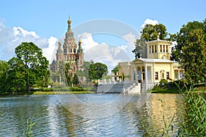 PETERHOF, RUSSIA. A view of a cathedral of Saints Pyotr and Pavel and Tsaritsyn the pavilion on the bank of Holguin of a pond