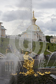 PETERHOF, SAINT PETERSBURG, RUSSIA - 15.08.2021 The Grand Cascade and Samson Fountain golden sculpture of Samson tearing open the