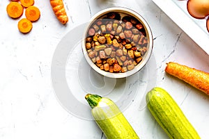 petfood set with vegetables and eggs on kitchen table top view mockup