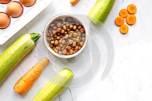 Petfood set with vegetables and eggs on kitchen table top view mockup