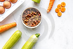 Petfood set with vegetables and eggs on kitchen table top view mockup