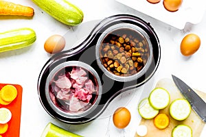 Petfood set with vegetables and meat on kitchen table background