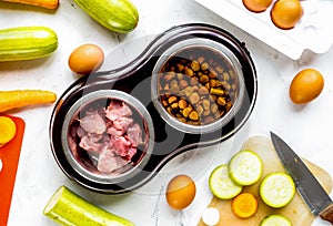 Petfood set with vegetables and meat on kitchen table background